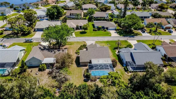 an aerial view of a house with swimming pool and outdoor space