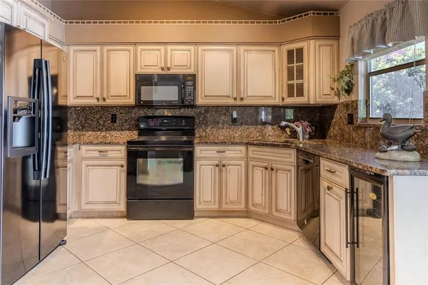 a kitchen with stainless steel appliances granite countertop a stove and a refrigerator