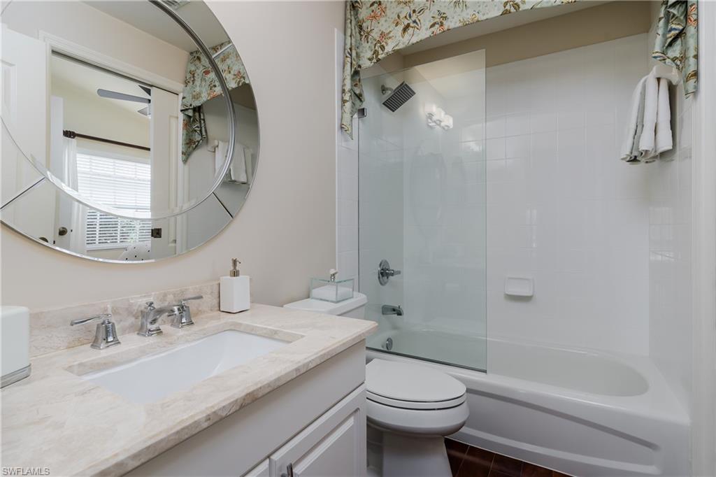 6658 Castlelawn Place, Unit 9 Naples, FL 34113 - Photo 24 of 38 Bathroom featuring a vanity with a light-toned countertop, an undermount sink, and chrome fixtures