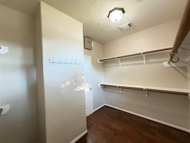 a view of a room with wooden floor