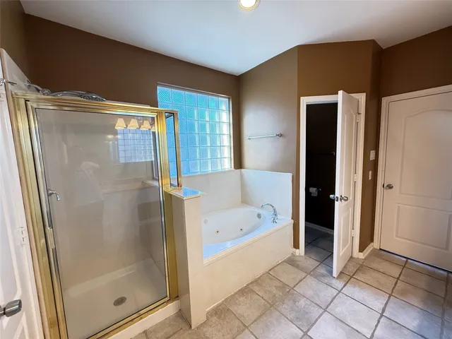 a bathroom with a bathtub and a shower