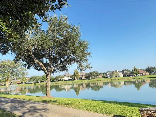 a view of a lake with houses in the background