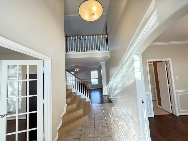 a view of entryway and hall with wooden floor