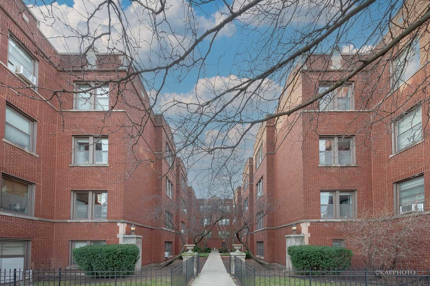 a view of a brick house with a yard