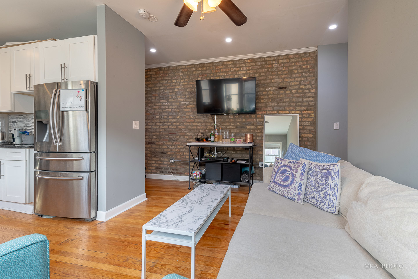 1323 West Addison Street, Unit 1B Chicago, IL 60613 - Photo 11 of 25 a living room with furniture and a flat screen tv