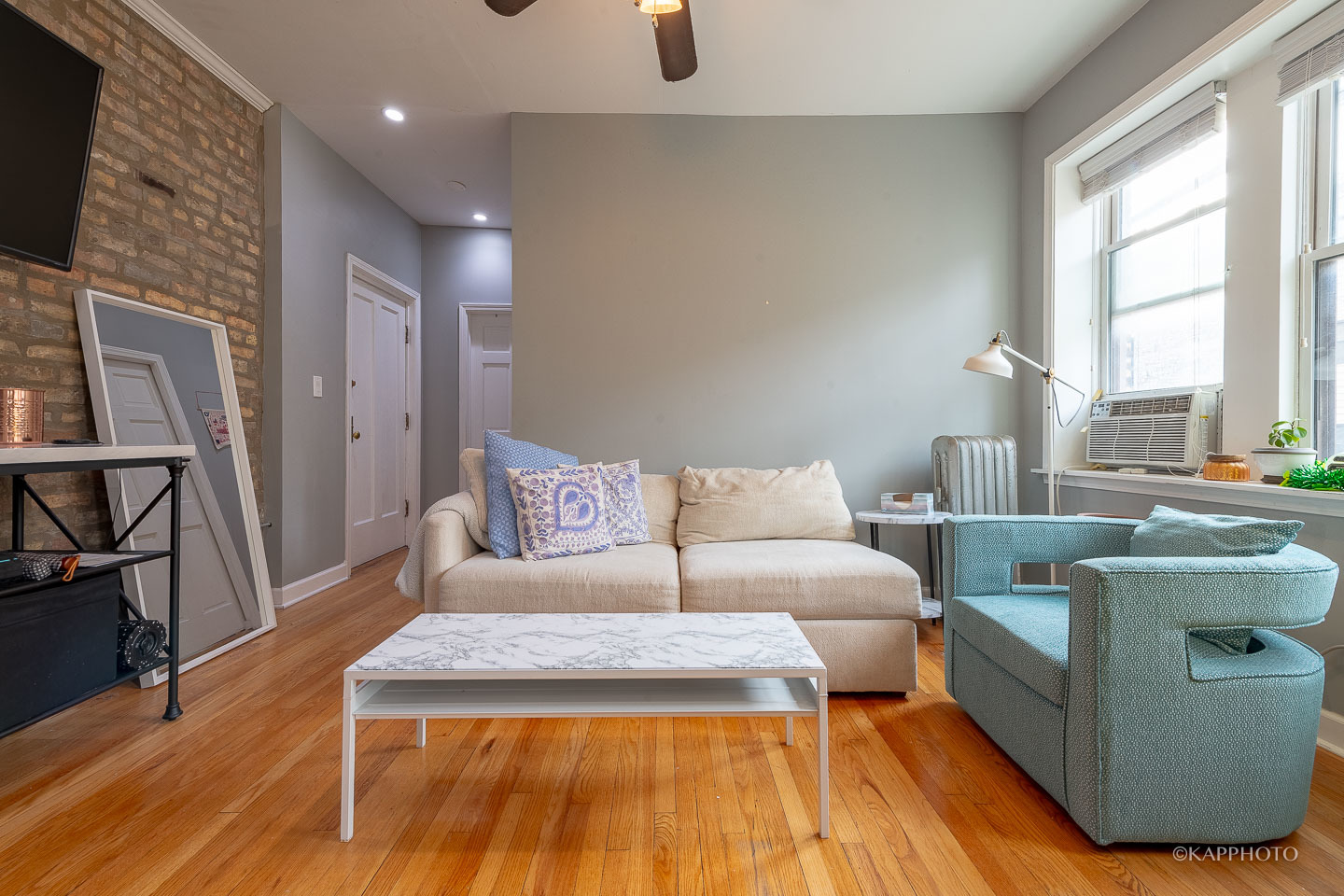 1323 West Addison Street, Unit 1B Chicago, IL 60613 - Photo 12 of 25 a living room with furniture and a table
