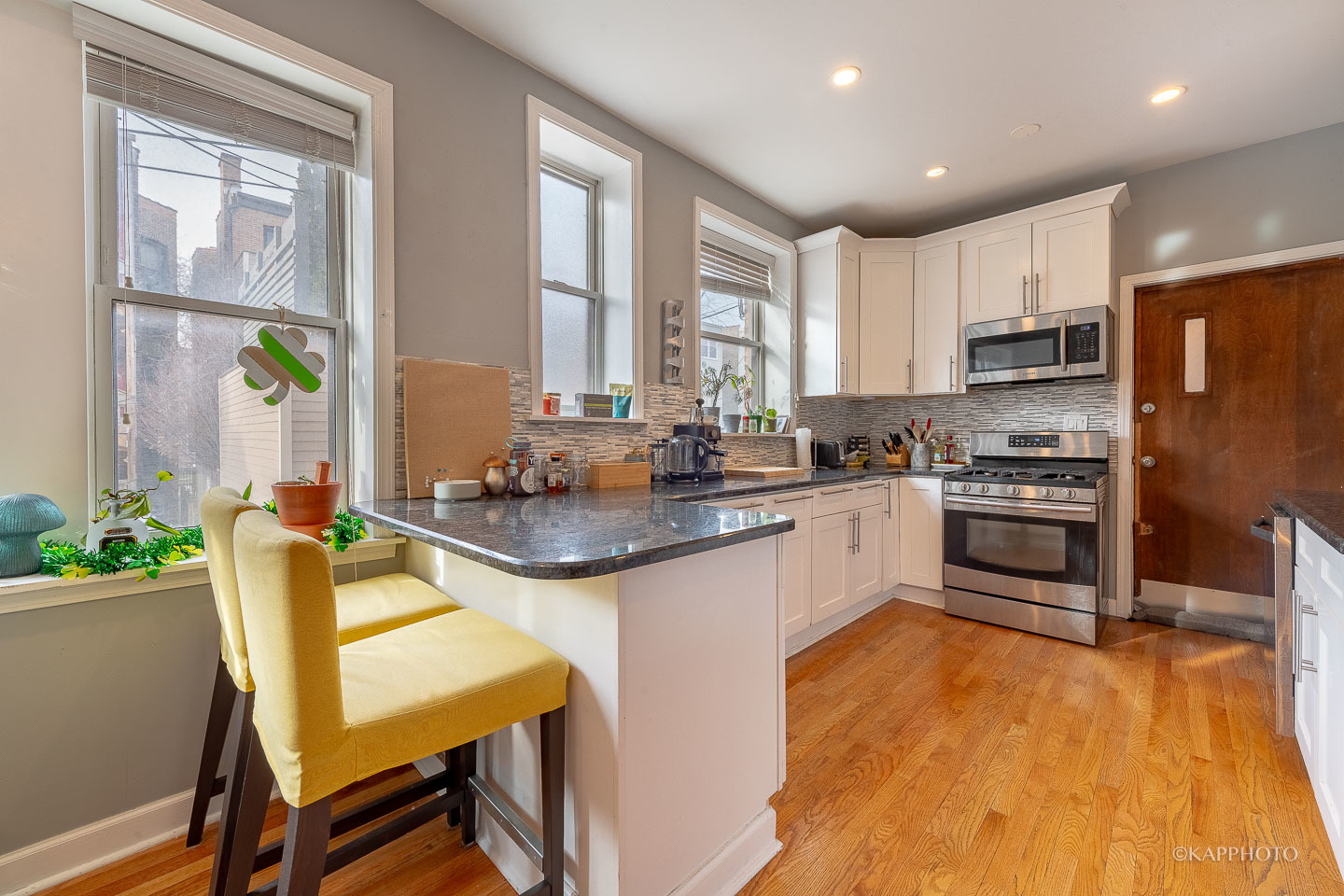 1323 West Addison Street, Unit 1B Chicago, IL 60613 - Photo 13 of 25 a kitchen with stainless steel appliances granite countertop a stove a sink and a refrigerator