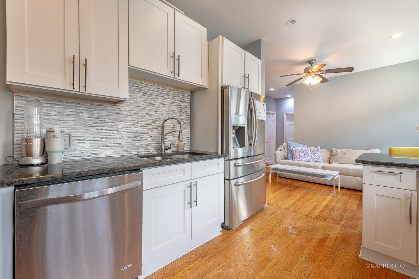 1323 West Addison Street, Unit 1B Chicago, IL 60613 - Photo 15 of 25 a kitchen with stainless steel appliances granite countertop a sink a stove and cabinets