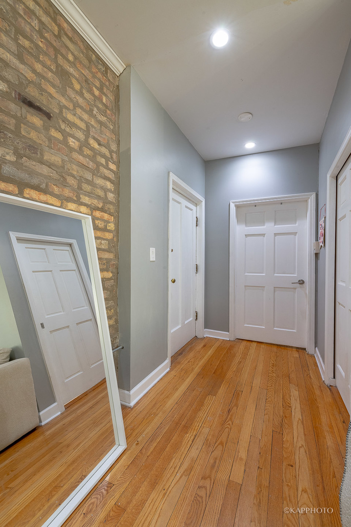 1323 West Addison Street, Unit 1B Chicago, IL 60613 - Photo 7 of 25 a view of empty room with wooden floor