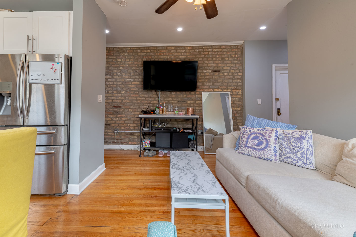 1323 West Addison Street, Unit 1B Chicago, IL 60613 - Photo 10 of 25 a living room with stainless steel appliances furniture a fireplace a flat screen tv and kitchen view