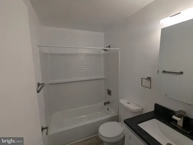 a bathroom with a toilet and a bath tub