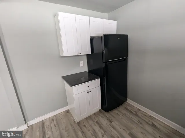 a kitchen with a refrigerator and a stove