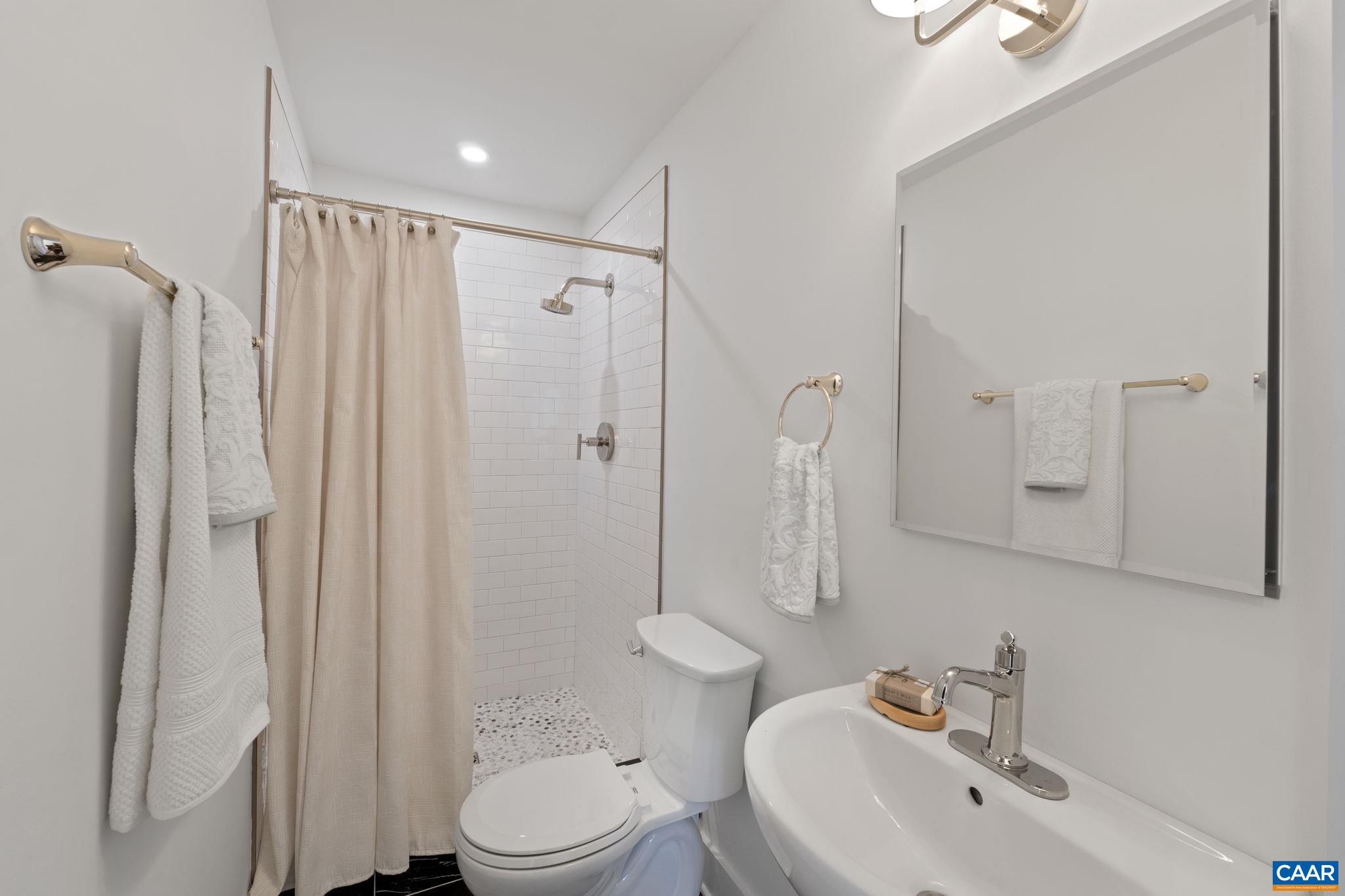 1404 Meadowbrook Road Charlottesville, VA 22903 - Photo 32 of 74 a bathroom with a sink a toilet and shower