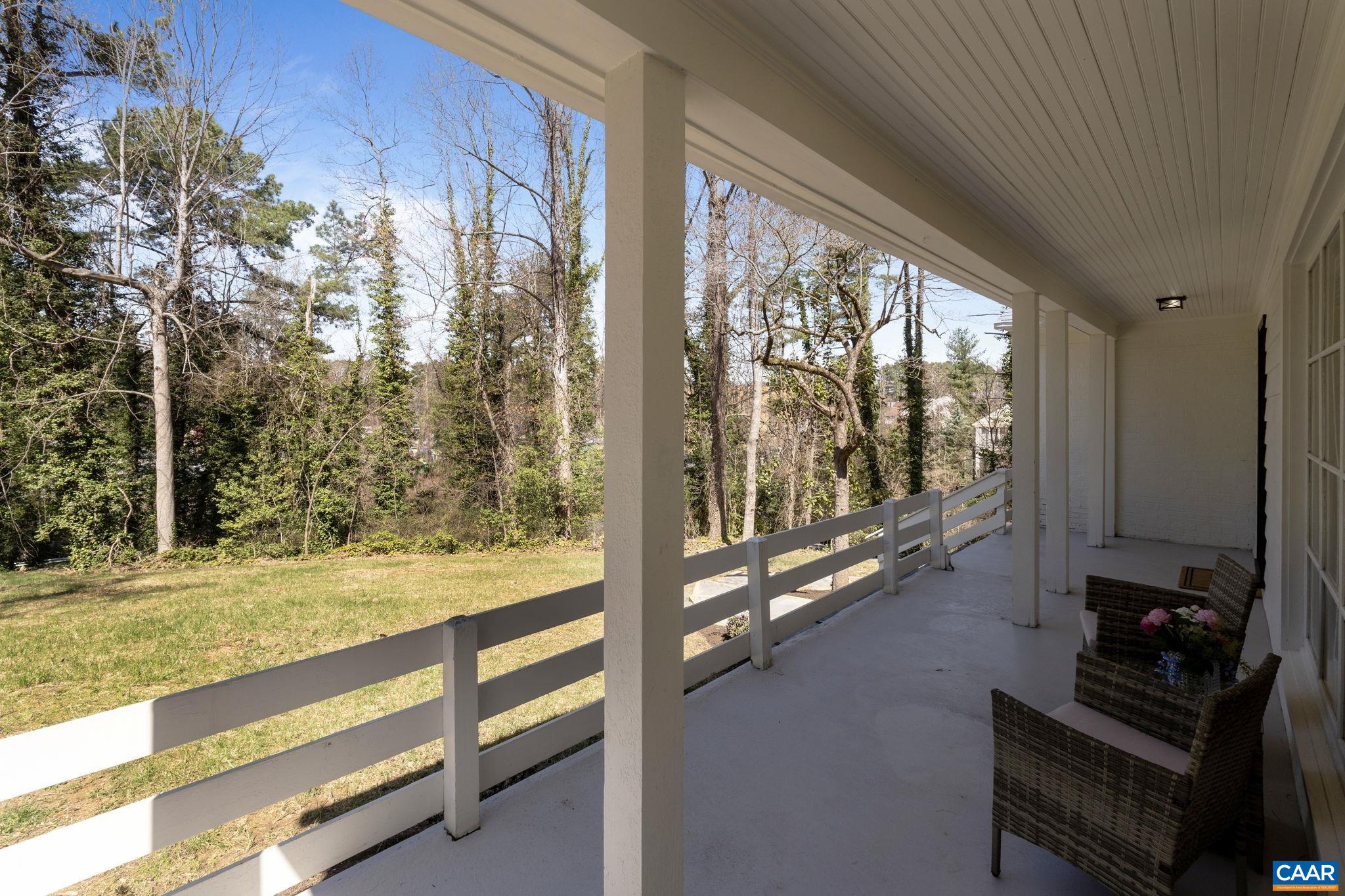 1404 Meadowbrook Road Charlottesville, VA 22903 - Photo 63 of 74 a view of an empty room with floor to ceiling windows and wooden floor