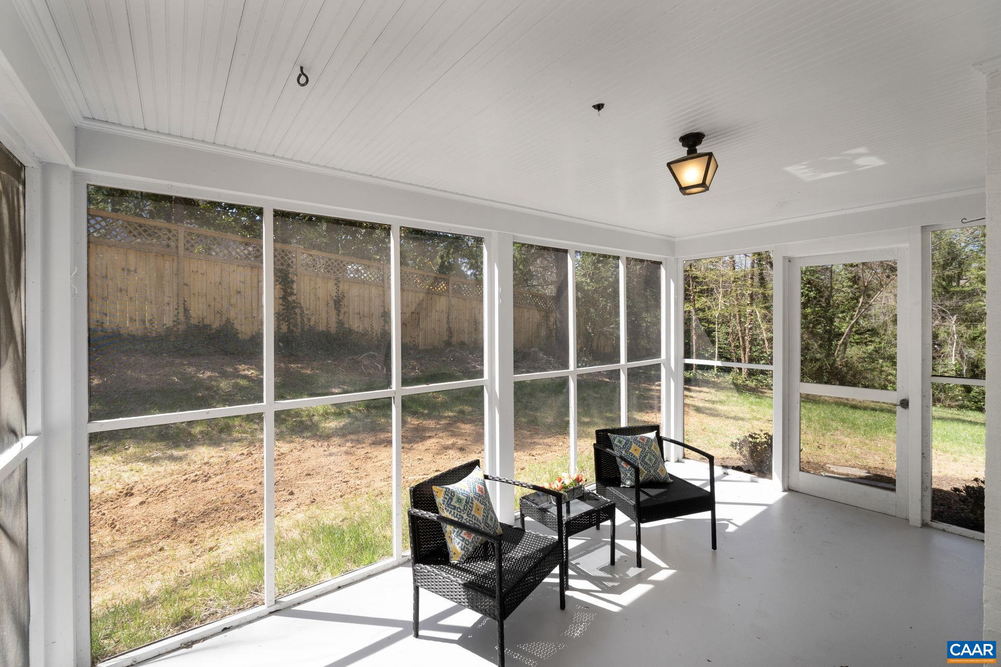 1404 Meadowbrook Road Charlottesville, VA 22903 - Photo 8 of 74 a living room with furniture and floor to ceiling windows