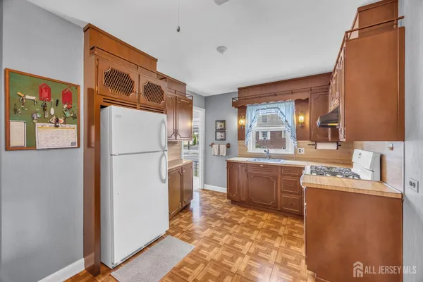 a kitchen with a refrigerator and a sink