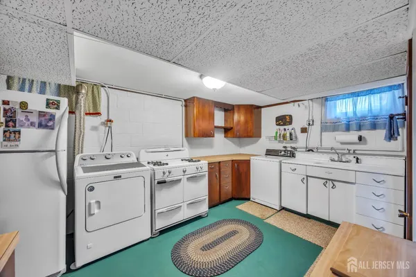 a kitchen with cabinets a sink and appliances