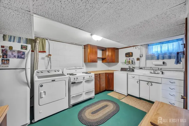 a kitchen with cabinets a sink and appliances