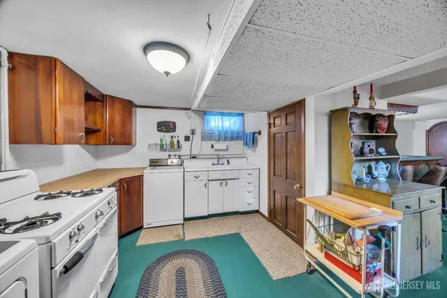 a kitchen that has a lot of cabinets a sink and a stove