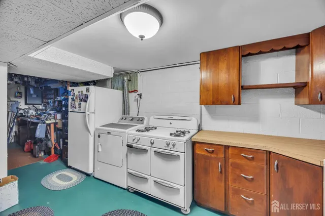 a kitchen with cabinets appliances and a counter space