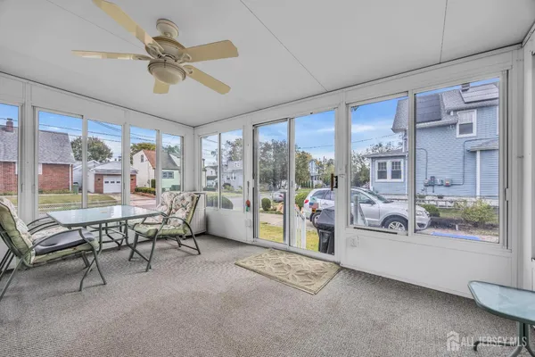 a dining room with furniture and a floor to ceiling window