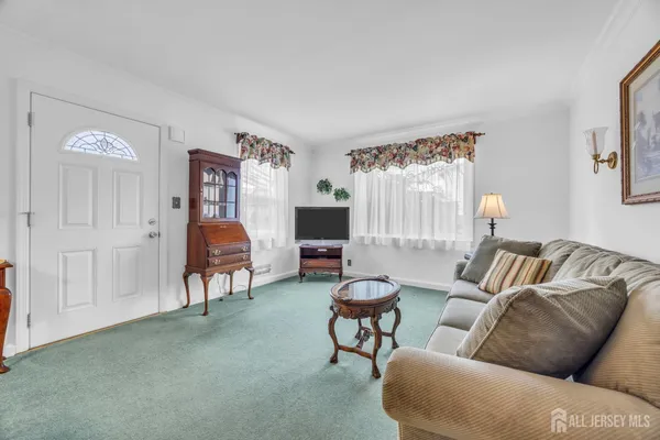 a living room with furniture and a lamp