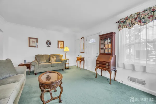 a living room with furniture and a piano