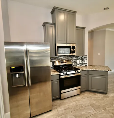 a view of a livingroom with a chandelier fan