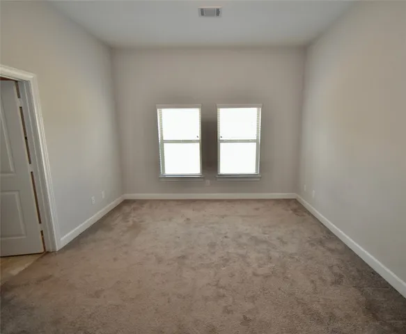 an empty room with closet area