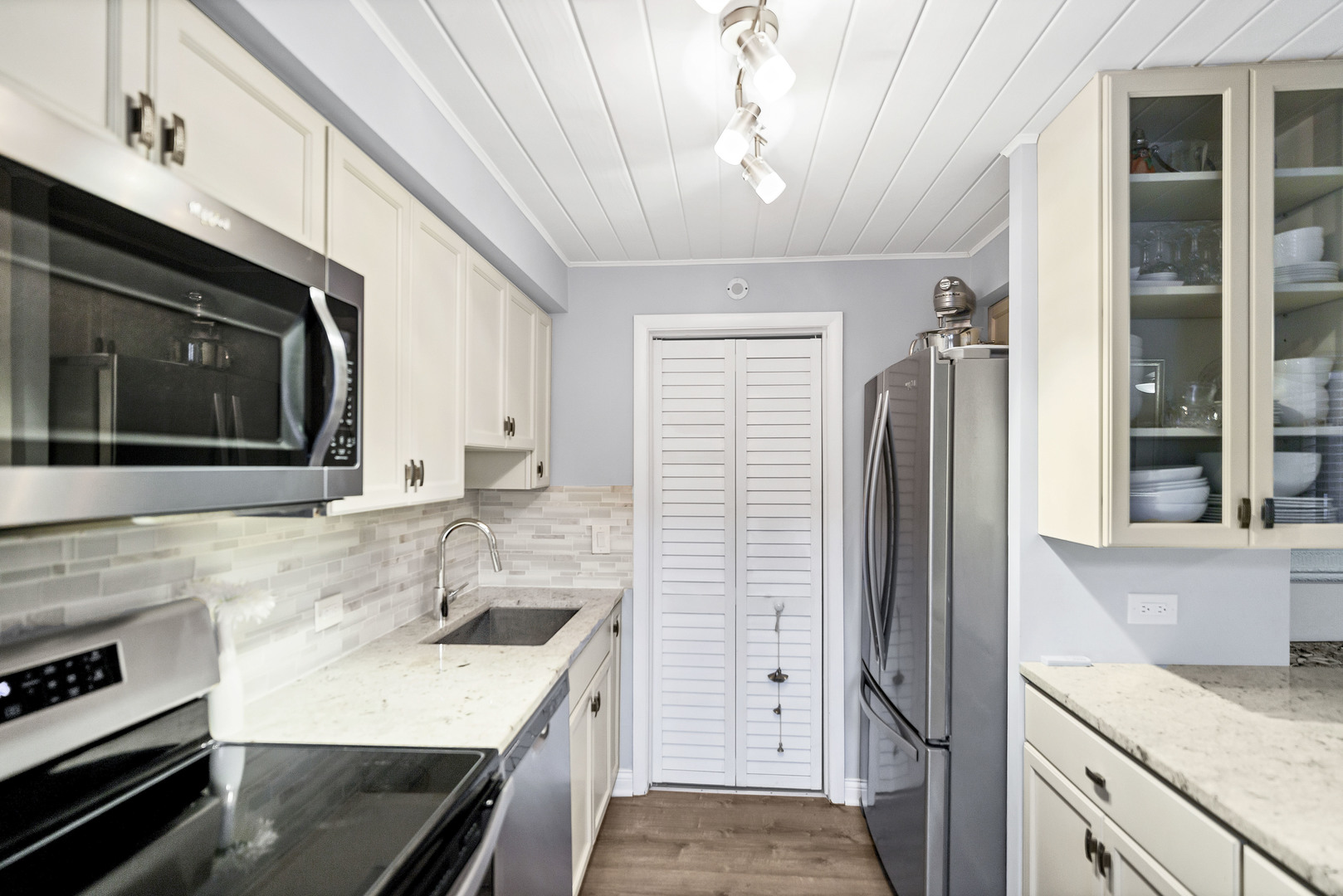 7754 West Higgins Road, Unit J Chicago, IL 60631 - Photo 11 of 23 a kitchen with a sink stove and refrigerator