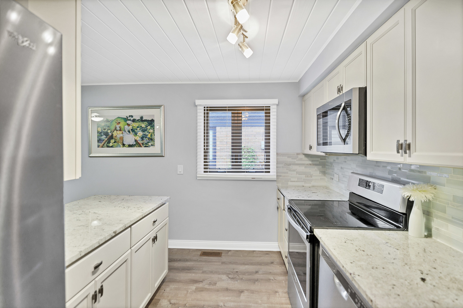 7754 West Higgins Road, Unit J Chicago, IL 60631 - Photo 12 of 23 a kitchen with stainless steel appliances granite countertop a sink stove and cabinets