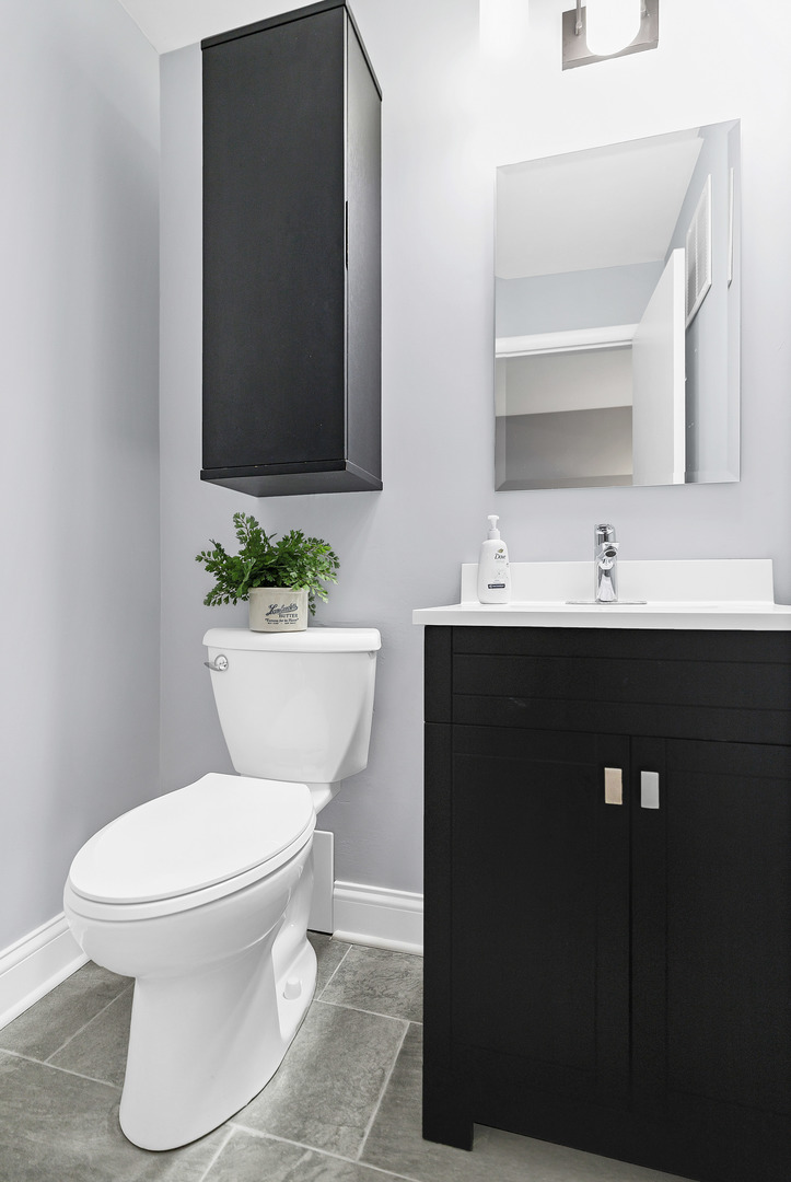 7754 West Higgins Road, Unit J Chicago, IL 60631 - Photo 15 of 23 a bathroom with a toilet sink and mirror