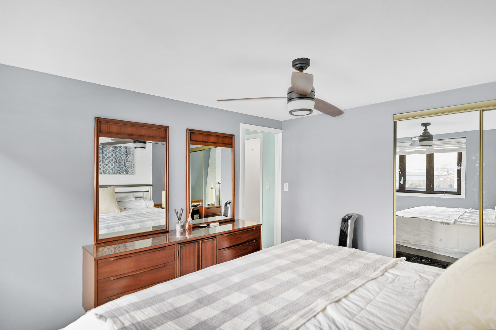 7754 West Higgins Road, Unit J Chicago, IL 60631 - Photo 17 of 23 a bedroom with a bed and a chandelier