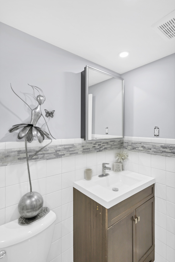 7754 West Higgins Road, Unit J Chicago, IL 60631 - Photo 21 of 23 a bathroom with a sink and a mirror