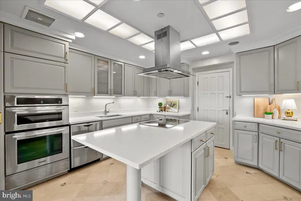 a kitchen with a stove a sink and a refrigerator