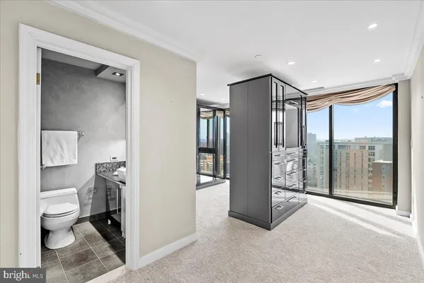 a spacious bathroom with a glass shower door and a toilet
