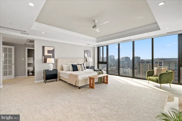 a spacious bedroom with a large bed and a large window