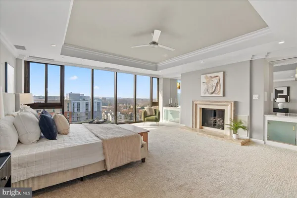 a living room with furniture fireplace and a large window