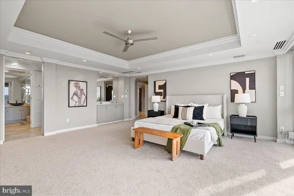 a spacious bedroom with a bed and ceiling fan