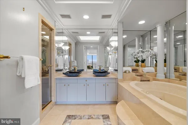 a large bathroom with a large mirror vanity and a sink