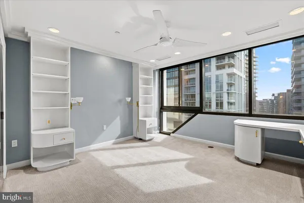 a large white room with a large window and furniture