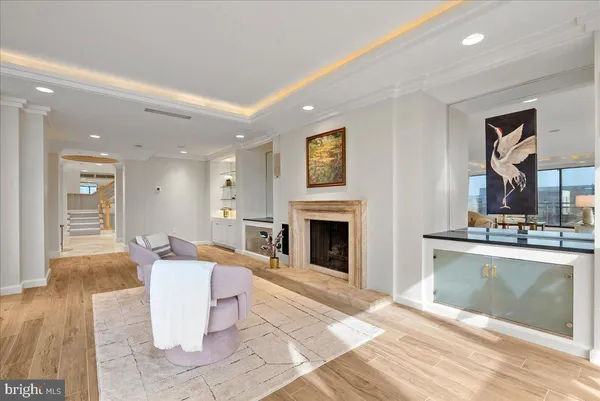 a living room with furniture a fireplace and a table
