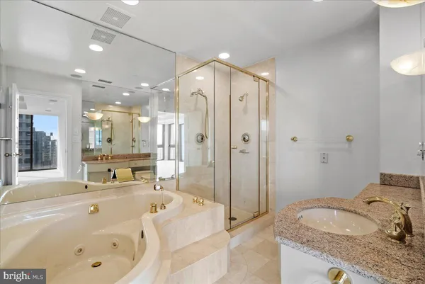 a spacious bathroom with a tub sink and shower