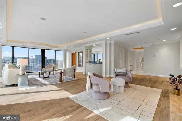 a living room with furniture and large windows