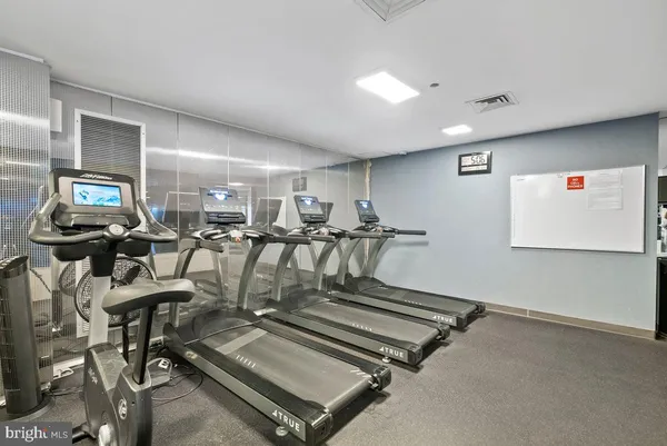 a room with gym equipment and a large window