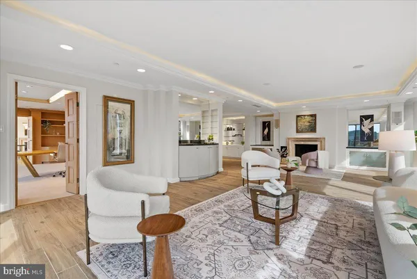 a living room with furniture and a view of kitchen