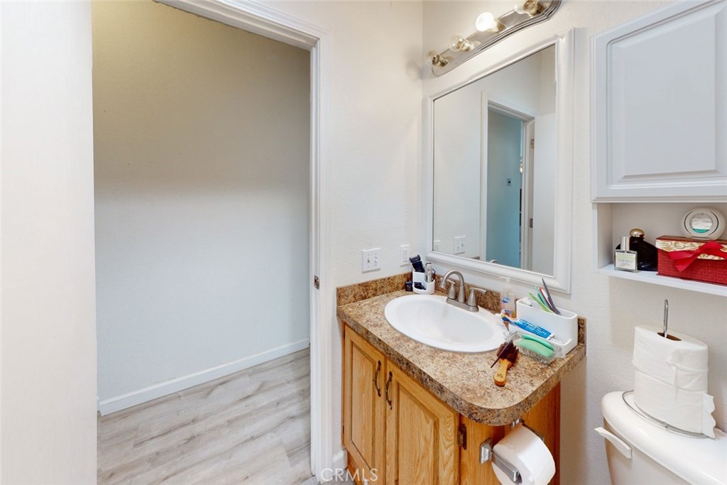 280 Canyon Creek Road Berry Creek, CA 95916 - Photo 20 of 36 a bathroom with a granite countertop sink toilet and a mirror