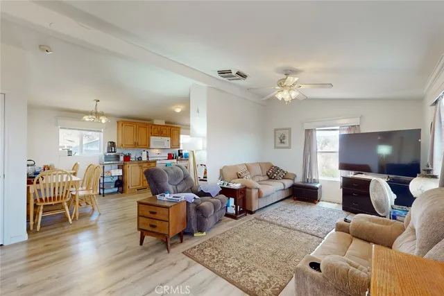 a living room with furniture a wooden floor and a chandelier