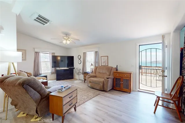 a living room with furniture flat screen tv and wooden floor