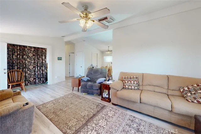 a living room with furniture rug and wooden floor